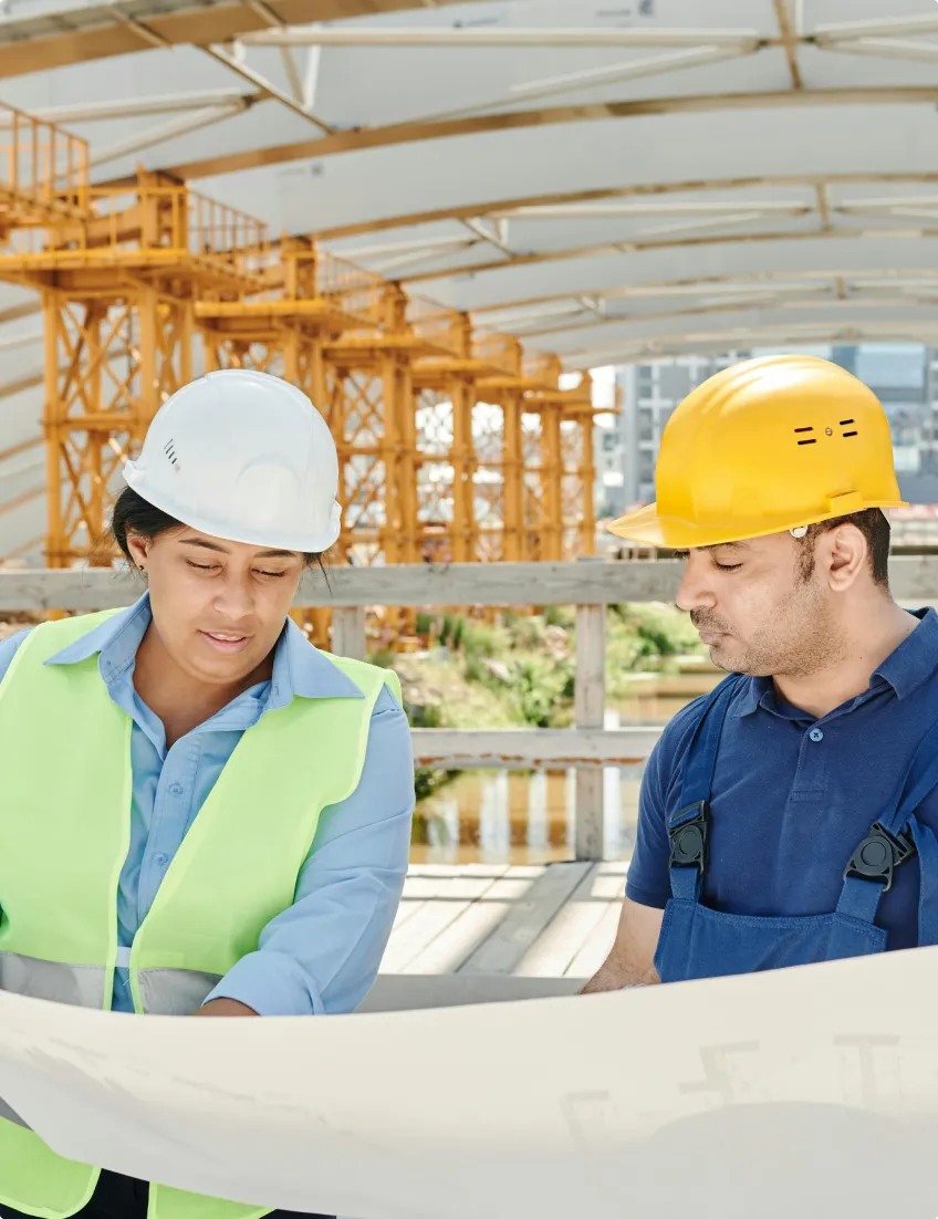 Installation engineers reviewing plans at a project site